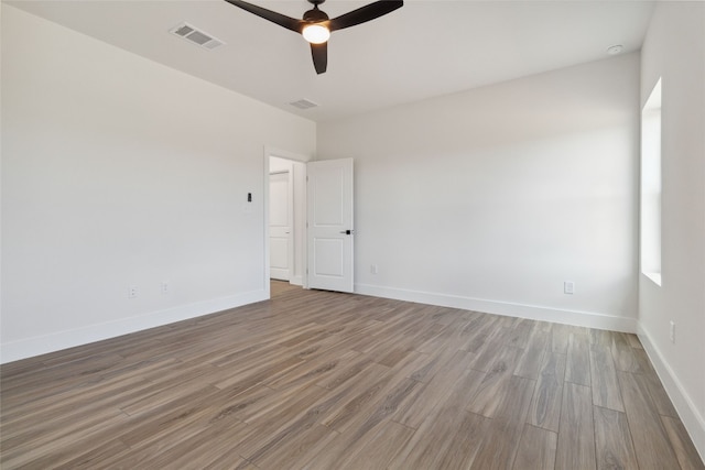 empty room with wood-type flooring and ceiling fan