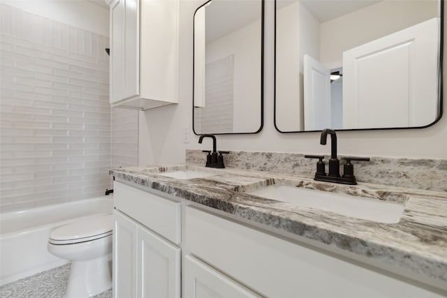 full bathroom with vanity, tiled shower / bath combo, and toilet