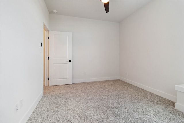 empty room featuring light colored carpet and ceiling fan