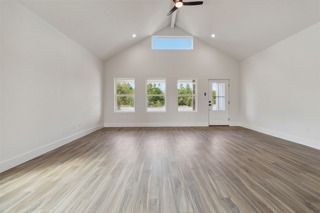 unfurnished living room with light hardwood / wood-style flooring, beamed ceiling, high vaulted ceiling, and ceiling fan