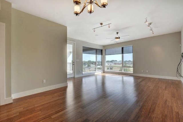 2612 W 12th St Unit 401, Austin, TX 78703 - empty room with a chandelier, wood finished floors, and baseboards