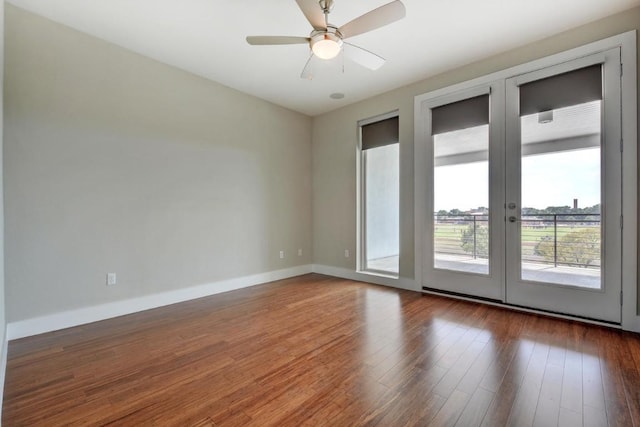 empty room with ceiling fan, dark wood-type flooring, and french doors