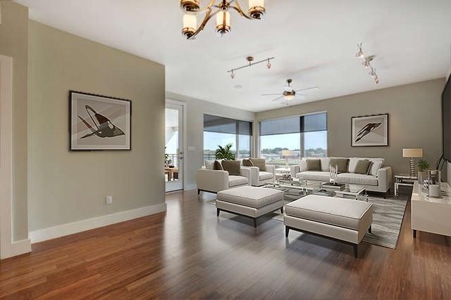 living room with dark hardwood / wood-style floors and ceiling fan with notable chandelier