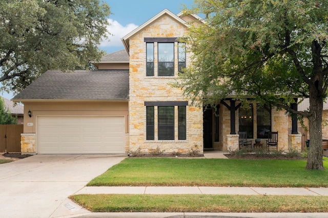 view of front of home featuring a garage and a front lawn