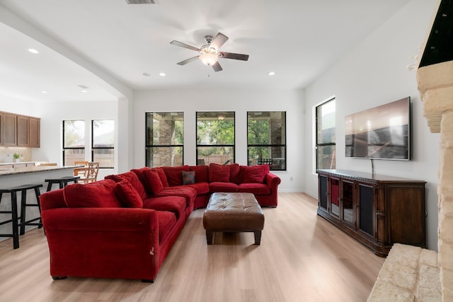 living room featuring light hardwood / wood-style floors and ceiling fan