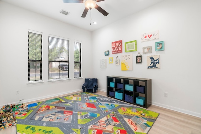 game room with ceiling fan and light hardwood / wood-style floors