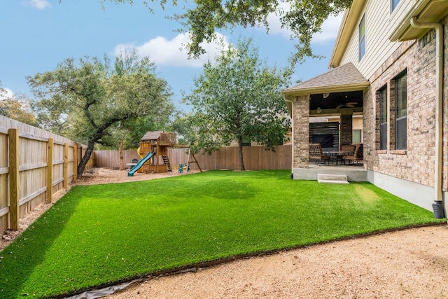 view of yard with a playground and a patio