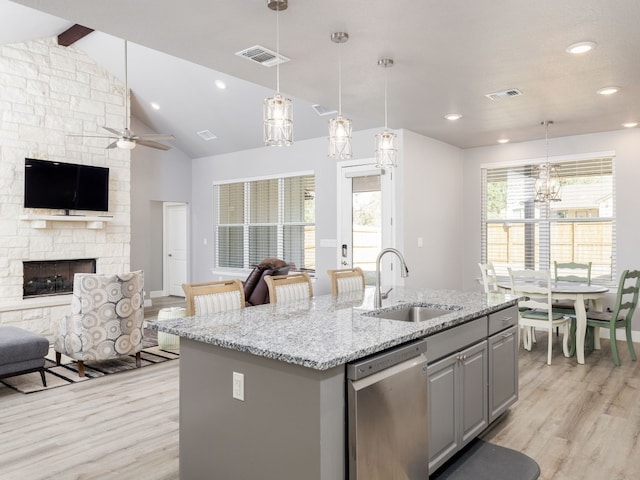 kitchen featuring gray cabinets, sink, a kitchen island with sink, and dishwasher