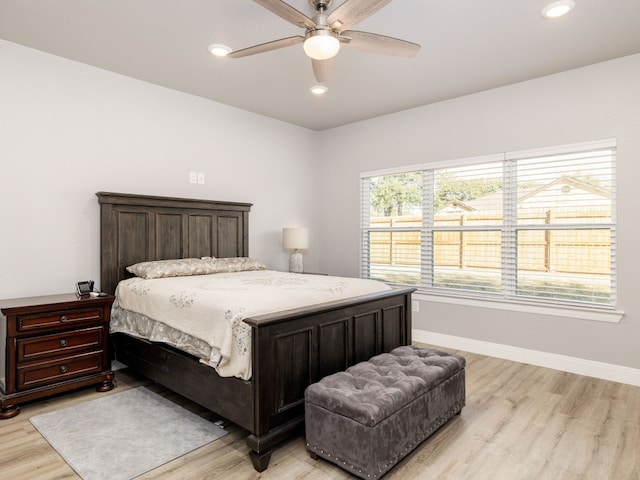 bedroom with light hardwood / wood-style floors and ceiling fan