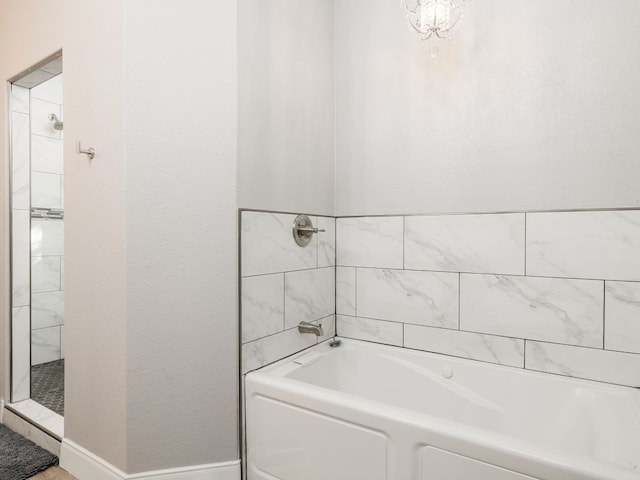 bathroom featuring separate shower and tub