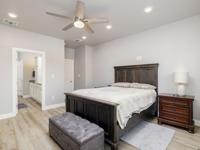 bedroom with light hardwood / wood-style flooring, ensuite bathroom, and ceiling fan