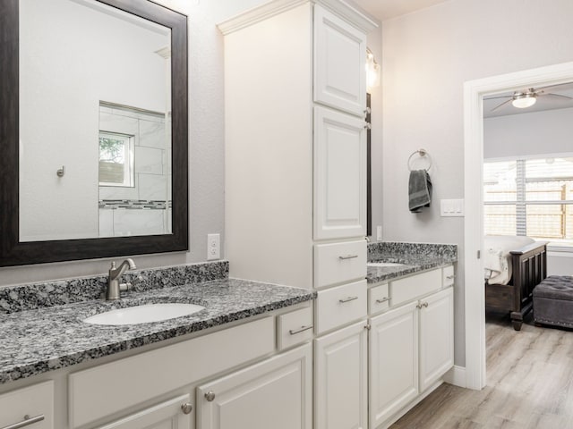 bathroom featuring vanity, wood-type flooring, and ceiling fan