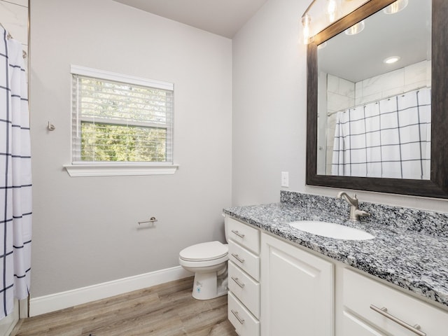 bathroom with vanity, a shower with curtain, hardwood / wood-style flooring, and toilet