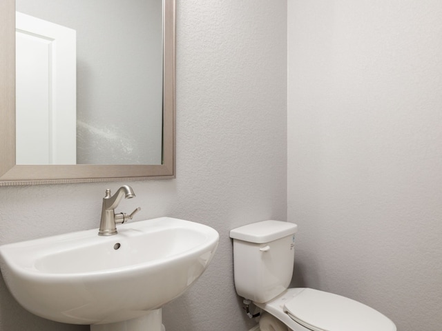 bathroom with toilet and sink