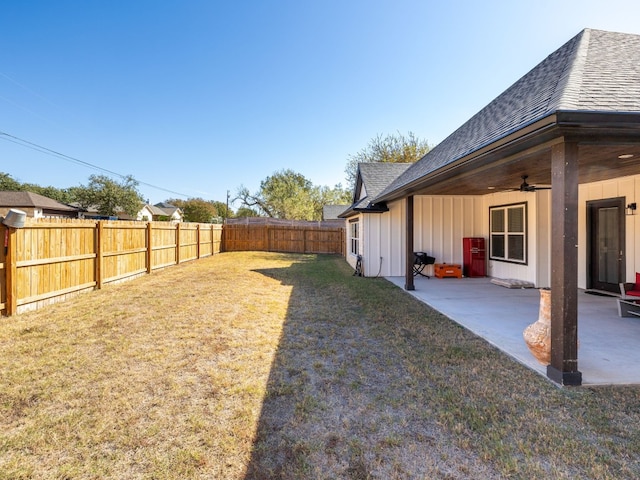 view of yard featuring a patio area and ceiling fan