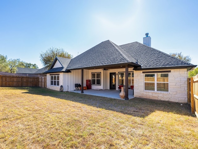 back of property featuring a patio area and a lawn