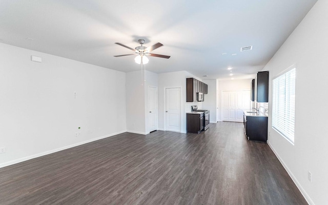 unfurnished living room with ceiling fan and dark wood-type flooring