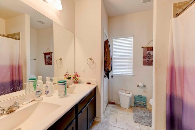 225 Shale Cir, Buda, TX 78610 - full bathroom with double vanity, tile patterned floors, curtained shower, baseboards, and toilet