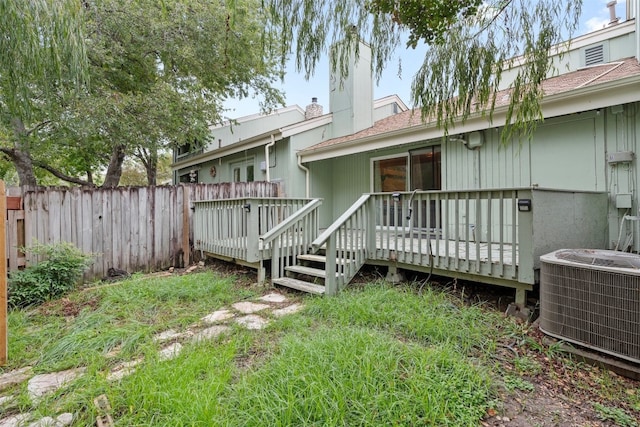 rear view of house featuring central AC and a deck