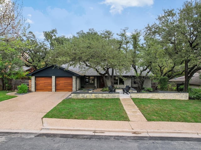 view of front of home featuring a garage and a front lawn