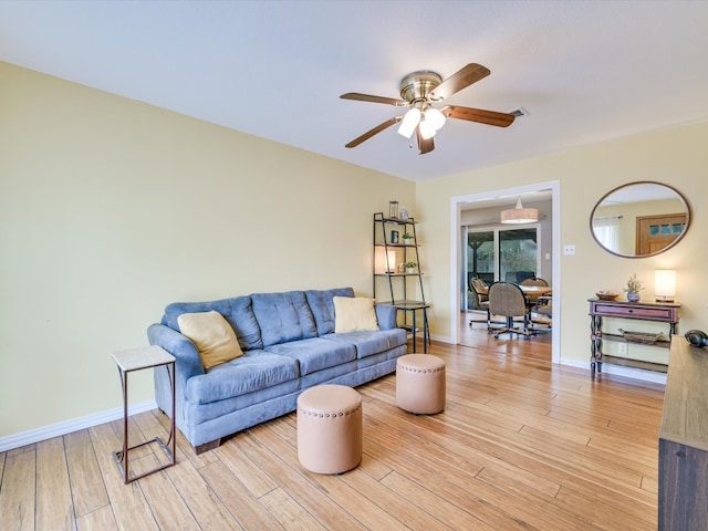 living room with light hardwood / wood-style floors and ceiling fan