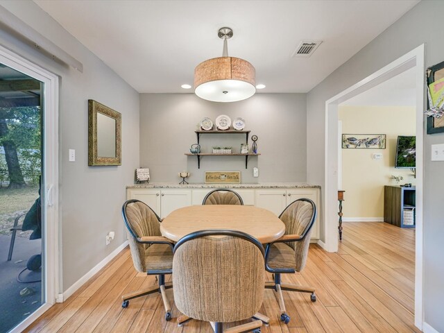 dining area with light hardwood / wood-style floors