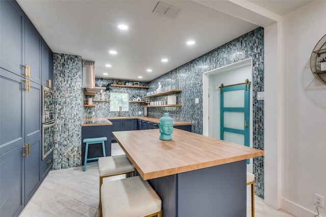 7612 Gault St, Austin, TX 78757 - kitchen with recessed lighting, a breakfast bar, butcher block counters, open shelves, and appliances with stainless steel finishes