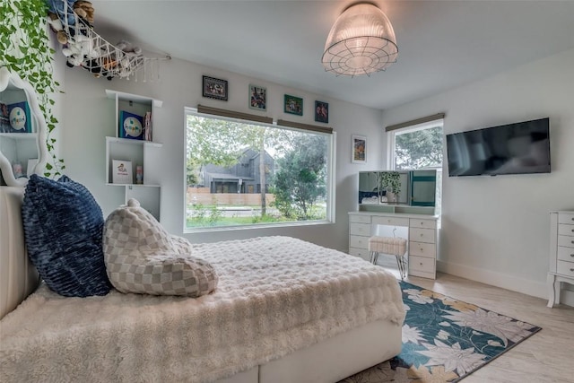 7612 Gault St, Austin, TX 78757 - bedroom with baseboards and wood finished floors