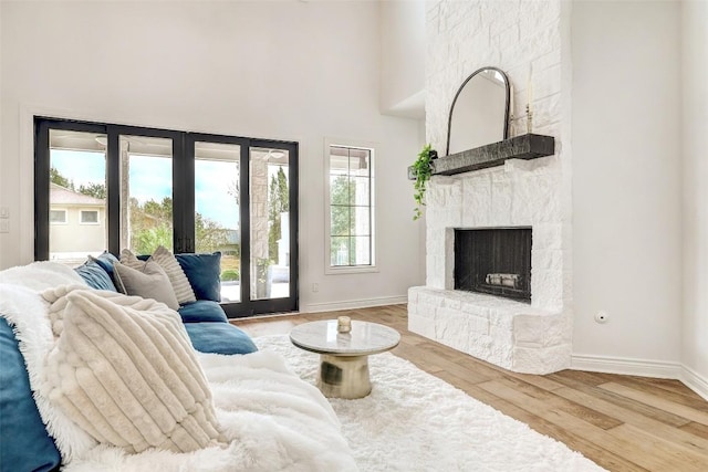 15006 Nightingale Ln, Austin, TX 78734 - living area with french doors, wood finished floors, a stone fireplace, and a towering ceiling