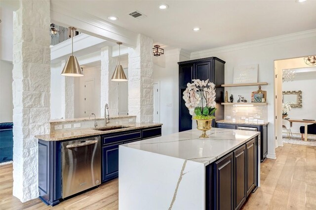 kitchen featuring crown molding, dishwasher, sink, and light wood-type flooring