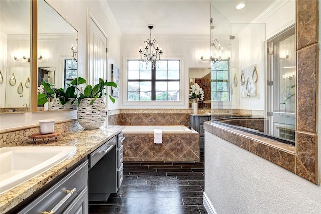 bathroom featuring crown molding, hardwood / wood-style flooring, an inviting chandelier, vanity, and separate shower and tub