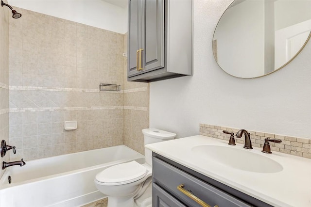 full bathroom with vanity, tiled shower / bath combo, decorative backsplash, and toilet