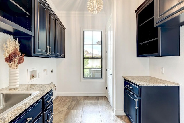 kitchen featuring sink, crown molding, and blue cabinets