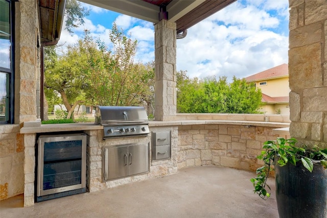 view of patio / terrace featuring a grill, beverage cooler, and exterior kitchen