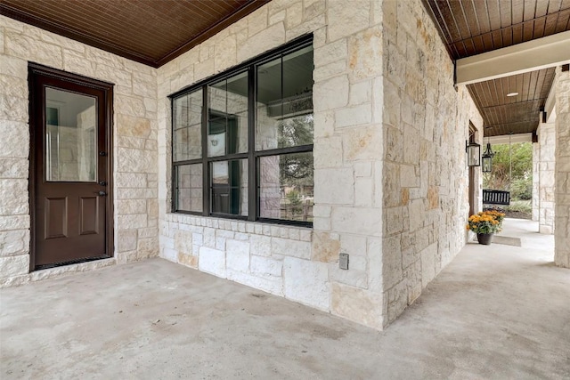 15006 Nightingale Ln, Austin, TX 78734 - view of exterior entry with stone siding and a porch