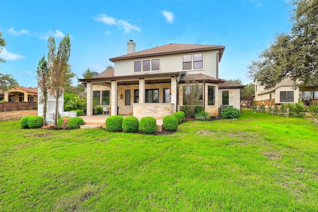 back of property featuring a patio, a yard, and ceiling fan