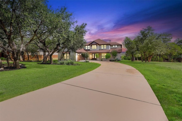 15006 Nightingale Ln, Austin, TX 78734 - view of front of home featuring curved driveway, a lawn, and stucco siding