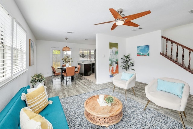 living room featuring light wood-type flooring and ceiling fan