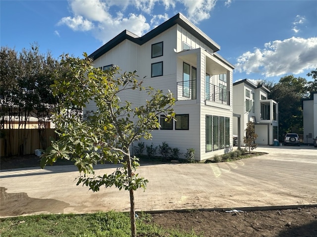 exterior space featuring a balcony and a garage