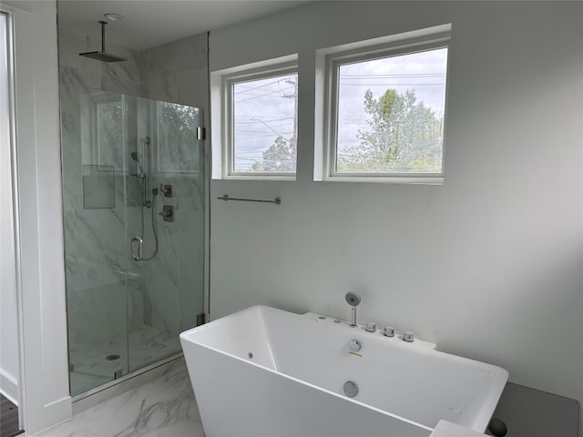 bathroom with separate shower and tub