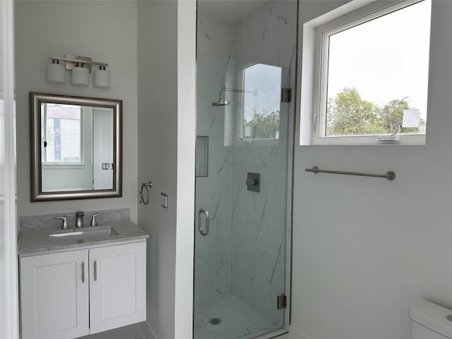 bathroom with vanity, toilet, and walk in shower