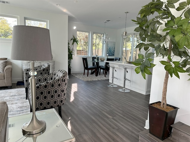 living room featuring dark wood-type flooring and a chandelier