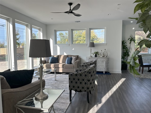 living room featuring dark hardwood / wood-style flooring and ceiling fan