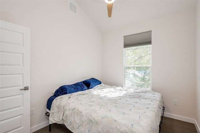 bedroom with dark wood-type flooring, ceiling fan, and vaulted ceiling