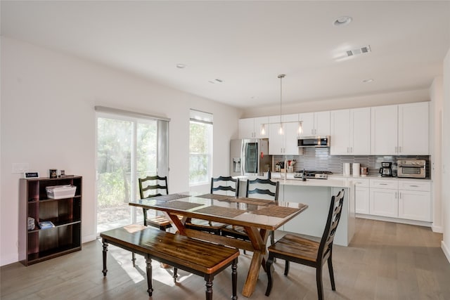 dining space with light wood-type flooring