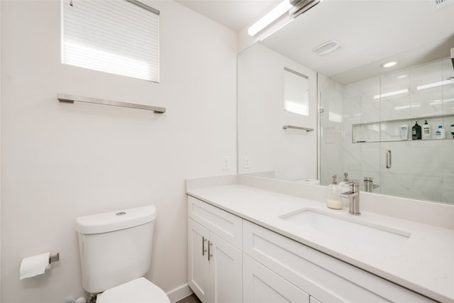 bathroom with a shower with door, vanity, and toilet