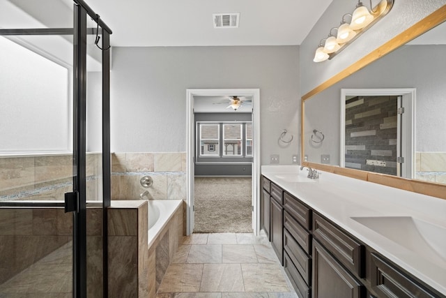 bathroom with ceiling fan, separate shower and tub, and vanity