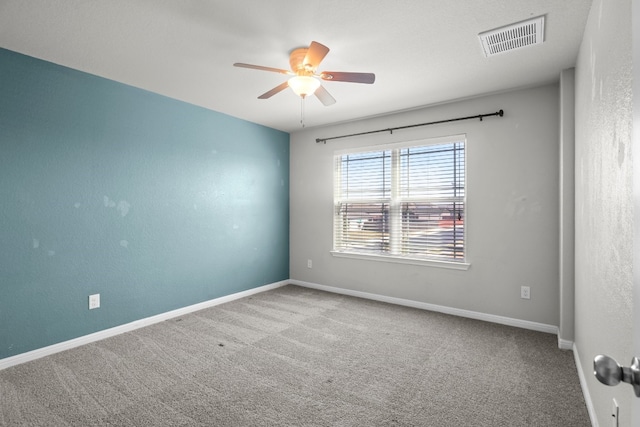 spare room with ceiling fan and carpet flooring