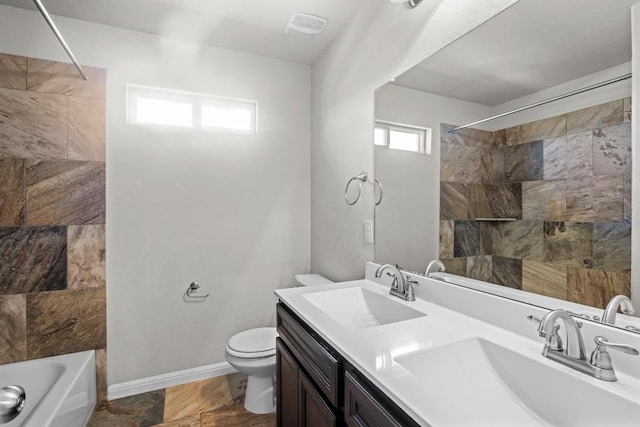 424 Hendelson Ln, Hutto, TX 78634 - bathroom with double vanity, toilet, shower / bath combination, and baseboards