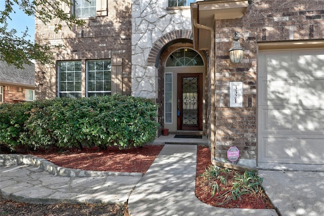 doorway to property with a garage